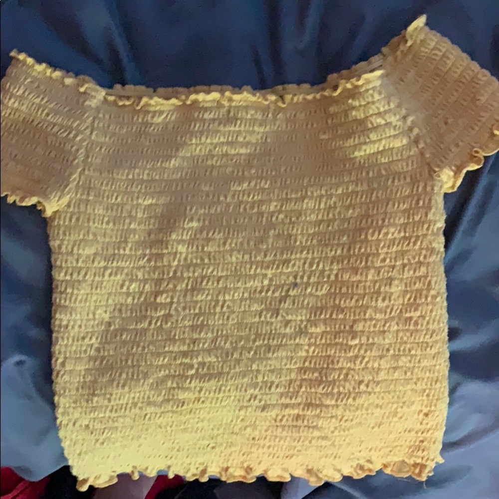 A yellow off the shoulder shirt
